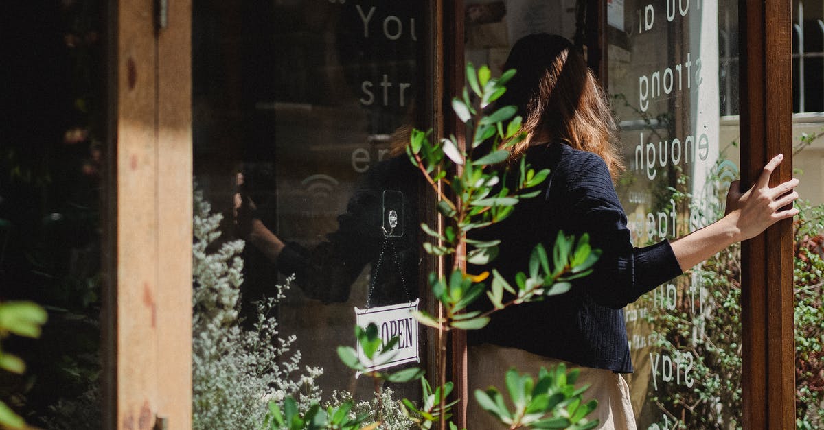 Can I work as a photo assistant when entering the US under the terms of VWP? [closed] - Woman closing door into flower shop
