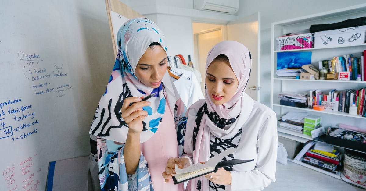 Can I work in Singapore without cancelling the Malaysia EP [closed] - Two Women In White Hijab Veils