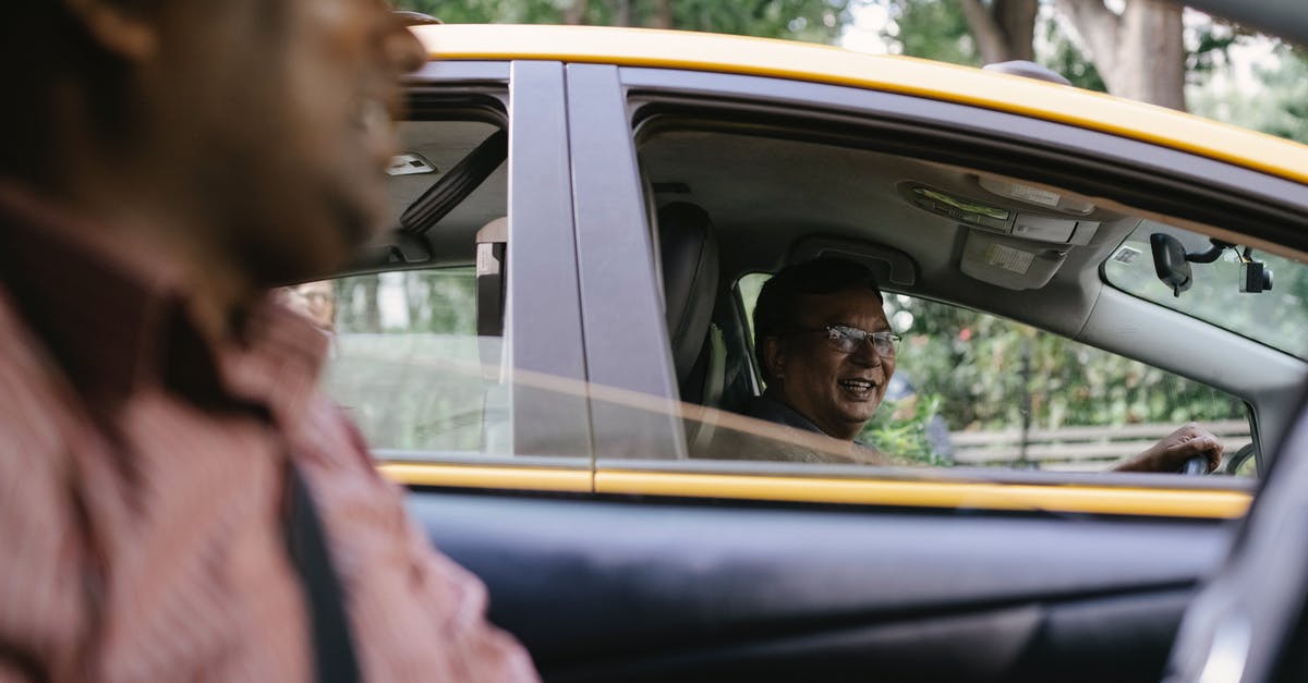 Can my friend legally drive my car in Canada? - Crop cheerful diverse taxi drivers talking in cars Can my friend legally drive my car in Canada? - Crop cheerful diverse taxi drivers talking in cars