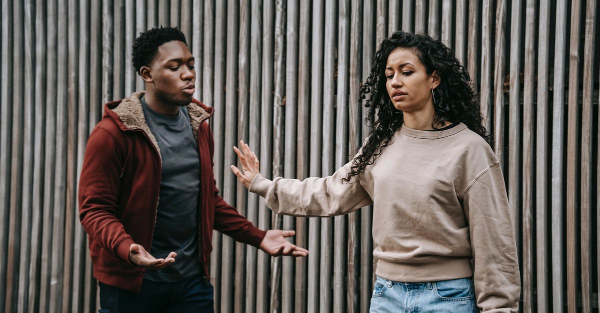 Can my Russian girlfriend leave the country if she owes the bank money? [duplicate] - Insulted ethnic girlfriend with outstretched arm and irritated African American boyfriend having quarrel near wooden wall on street during breakup