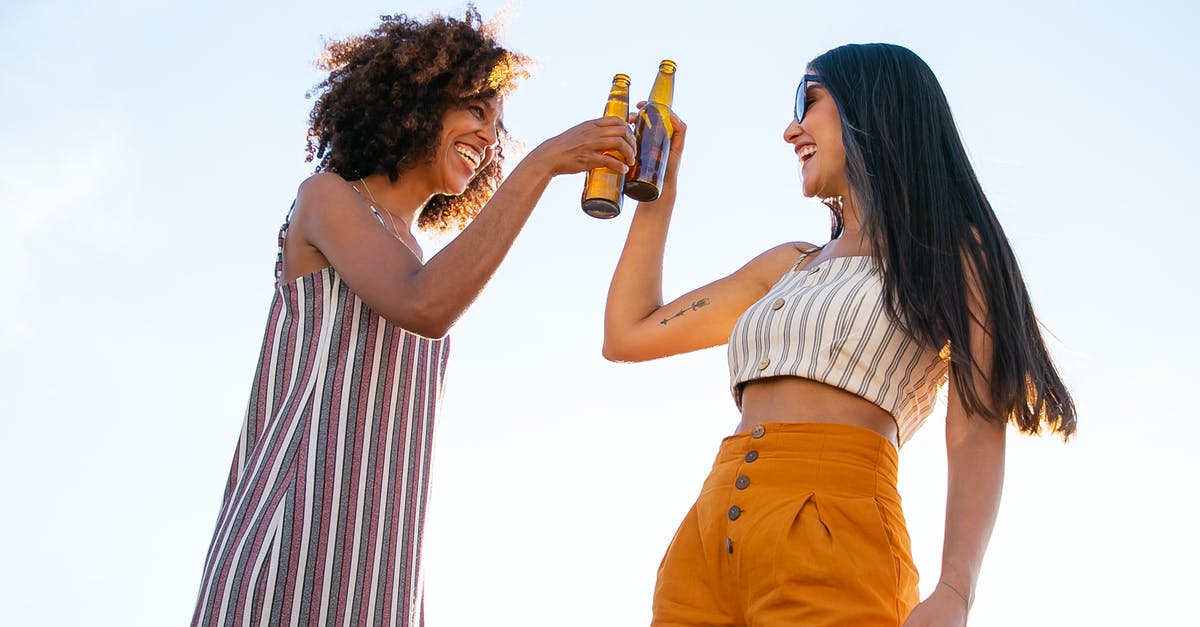Can others in my party go through TSA PreCheck? - Low angle of delighted multiracial female friends toasting with bottles of beer while laughing together during party Can others in my party go through TSA PreCheck? - Low angle of delighted multiracial female friends toasting with bottles of beer while laughing together during party