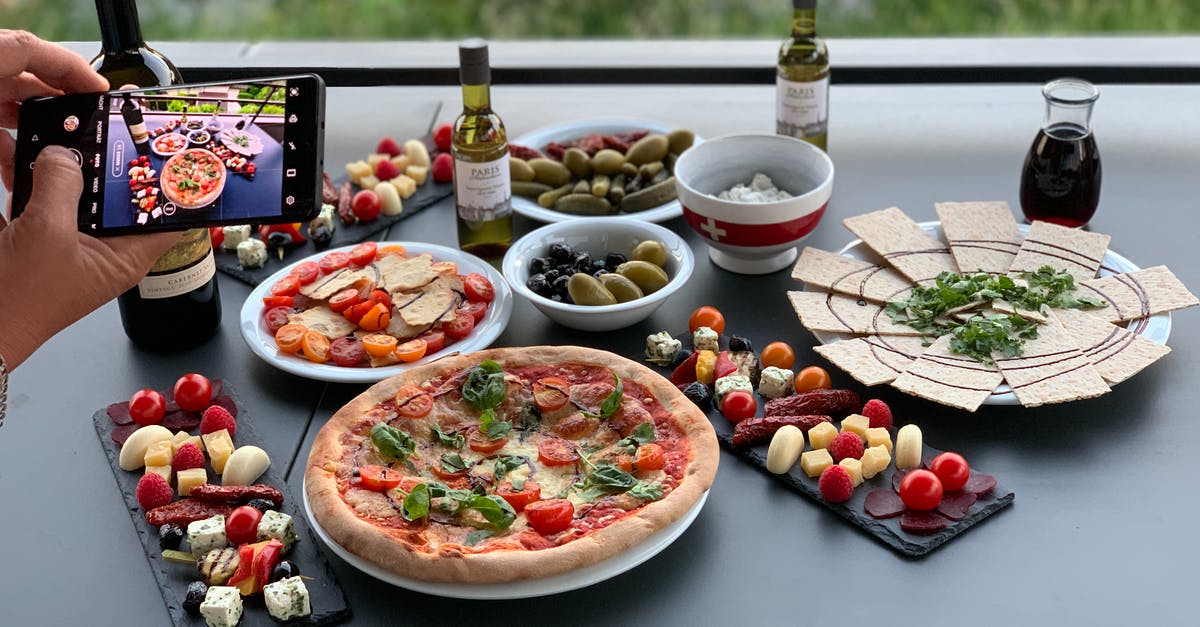 Can person take a toothpick from a restaurant in Japan? - Unrecognizable person photographing table with pizza and assorted snacks Can person take a toothpick from a restaurant in Japan? - Unrecognizable person photographing table with pizza and assorted snacks
