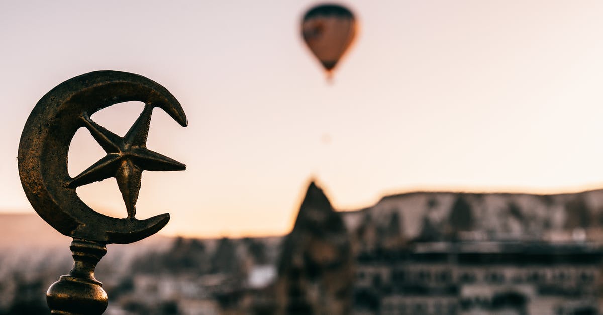 Can Polish citizens enter Turkey for transit with National ID? - Soft focus of Turkey symbols on top of building against floating air balloon under Cappadocia terrain at dawn Can Polish citizens enter Turkey for transit with National ID? - Soft focus of Turkey symbols on top of building against floating air balloon under Cappadocia terrain at dawn