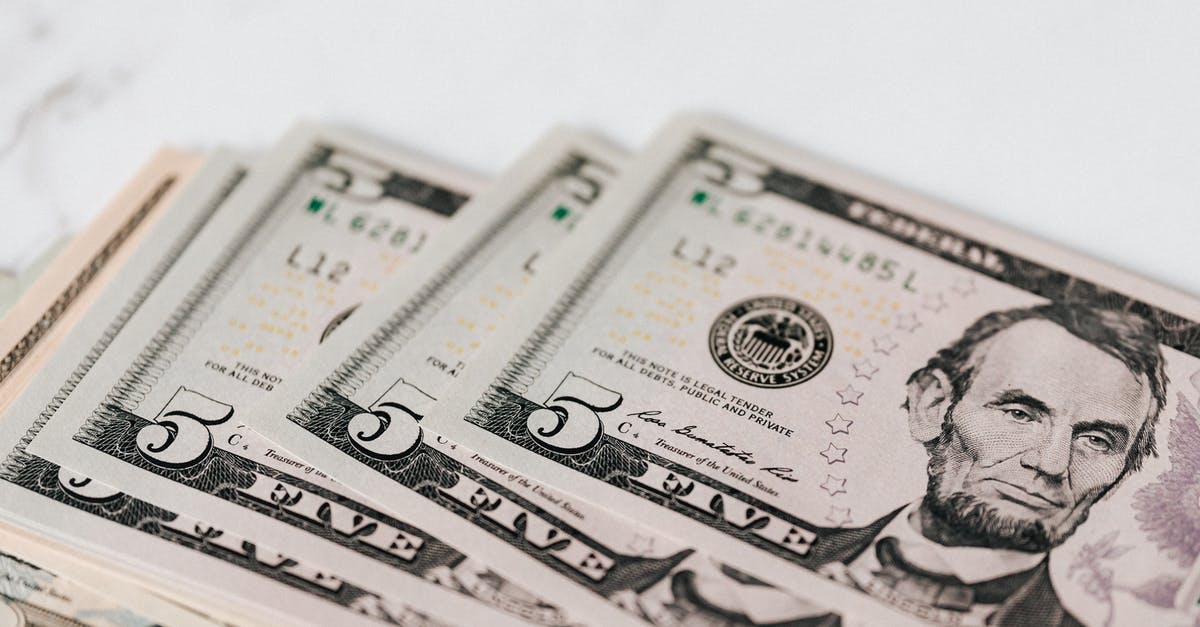 Can power banks be recharged from both 120V and 240V? - From above of pile of five dollar bills placed on white marble surface Can power banks be recharged from both 120V and 240V? - From above of pile of five dollar bills placed on white marble surface