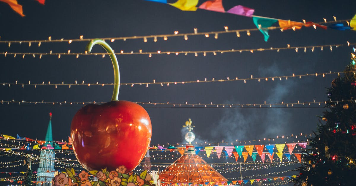 Can Russians exit Russia on an internal passport? - Big red glossy toy apple on roof of building on fairground against dark sky in evening city park decorated to winter holidays Can Russians exit Russia on an internal passport? - Big red glossy toy apple on roof of building on fairground against dark sky in evening city park decorated to winter holidays
