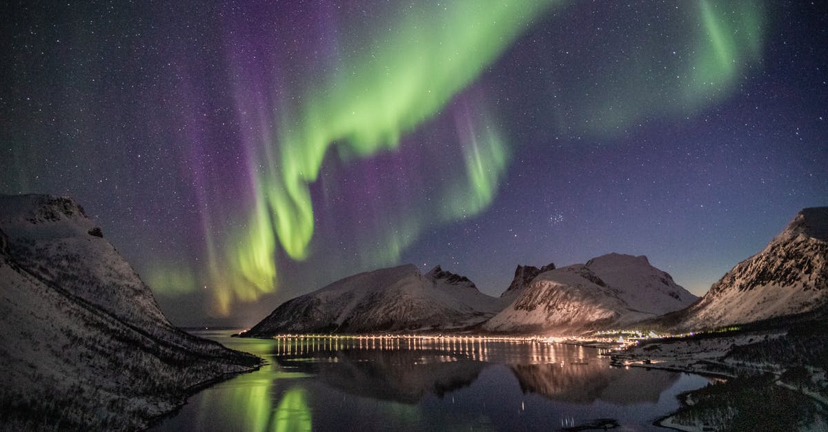 Can the aurora and snow be seen at Rovaniemi in October? - Mountain Beside Body of Water With Aurora Borealis