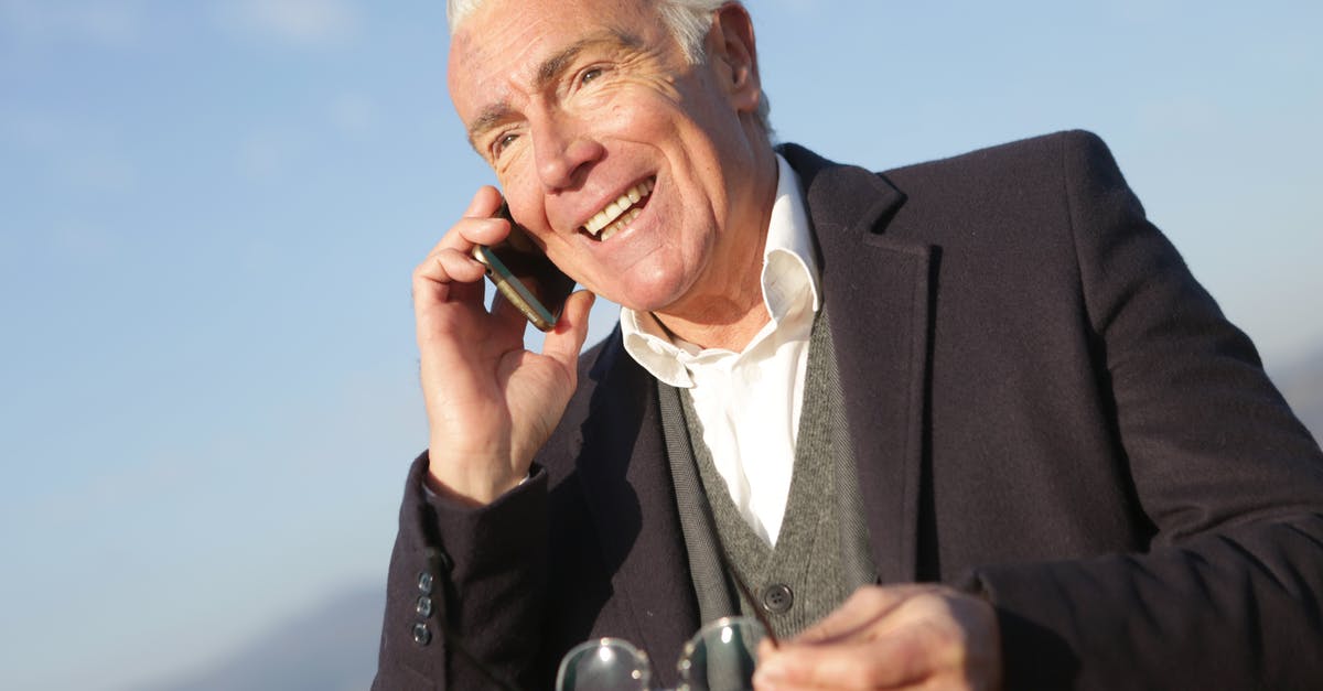 Can two new and one old mobile phones be taken to India? [duplicate] - Mature businessman having conversation on smartphone in city