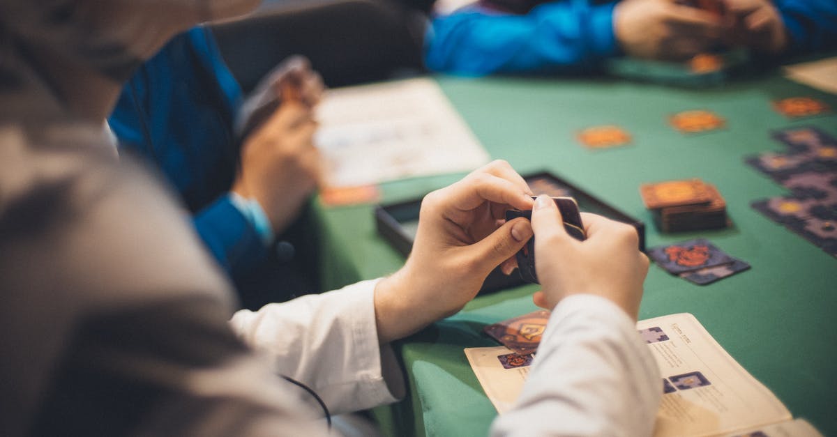 Can two people share a 12-trip tallinja card when traveling together? - Crop people playing cards at table Can two people share a 12-trip tallinja card when traveling together? - Crop people playing cards at table