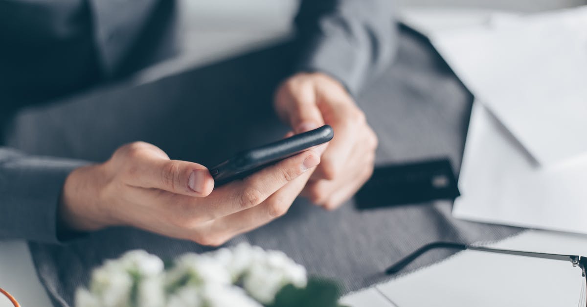 Can we hold more than 1 multi-currency travel card in India? - Person Holding Black Android Smartphone