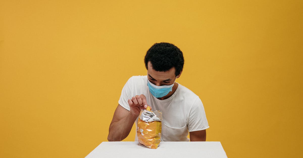 Can you eat food refused by quarantine by Australian border control? - Man in White Crew Neck T-shirt Eating Chips