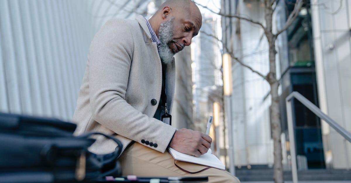 Can you get a passport with paper ID and Expired ID? - An Elderly Man Writing on his Notebook