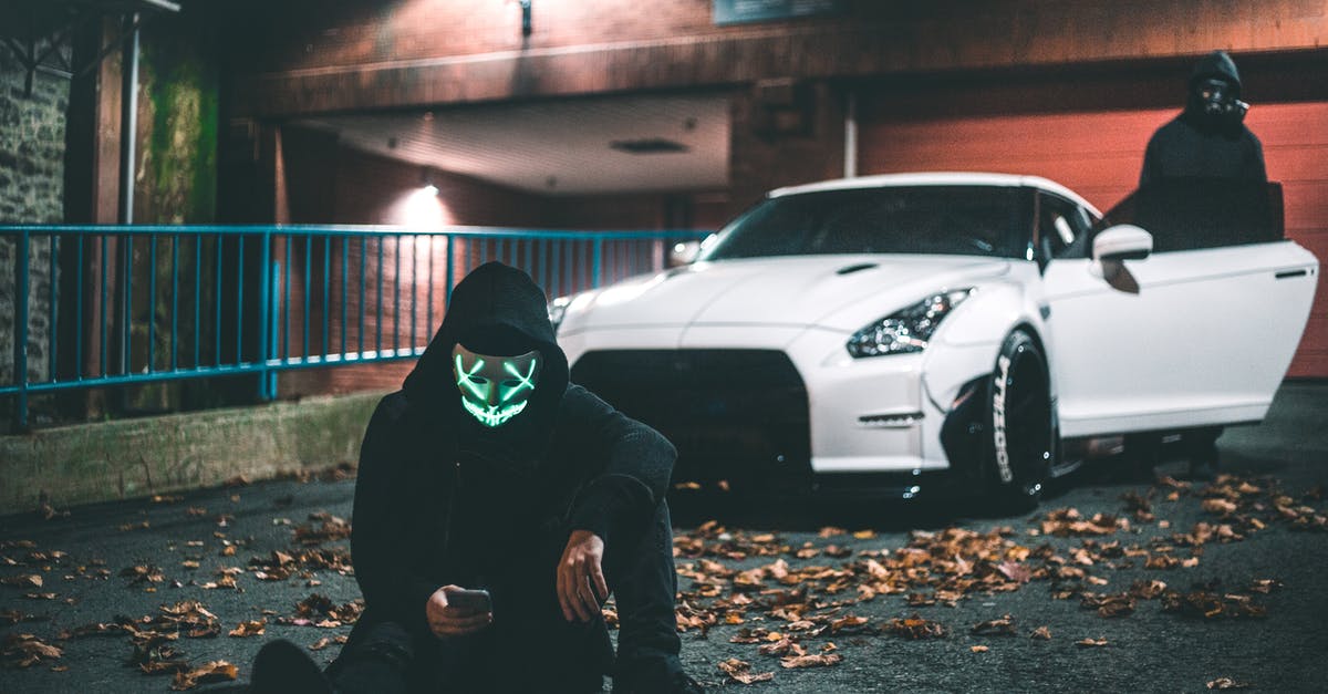 Can you give your Swiss motorway vignette to a friend after using it on your car? - Anonymous male in neon mask browsing internet on cellphone while sitting on asphalt road covered with faded leaves near modern auto and friend standing on illuminated street at night Can you give your Swiss motorway vignette to a friend after using it on your car? - Anonymous male in neon mask browsing internet on cellphone while sitting on asphalt road covered with faded leaves near modern auto and friend standing on illuminated street at night