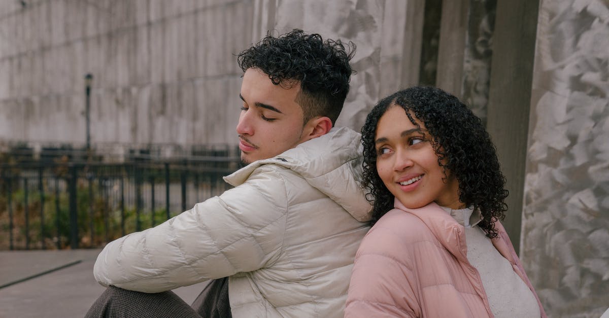 Can you "back date" a European working holiday visa so past Schengen time doesn't count? [closed] - Relaxed happy young ethnic man and woman with curly hair in casual clothes sitting back to back during date in park