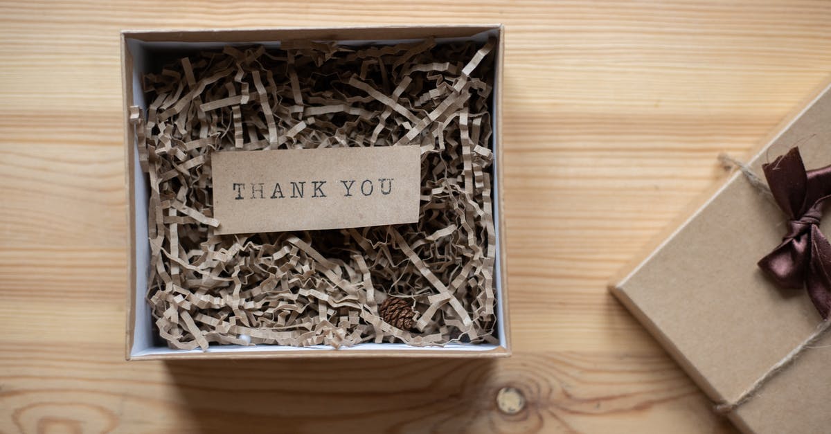 Can you receive mail at hotels weeks before you arrive? - Top view of opened carton present box with small postcard with Thank You inscription and paper stuffing on wooden table Can you receive mail at hotels weeks before you arrive? - Top view of opened carton present box with small postcard with Thank You inscription and paper stuffing on wooden table