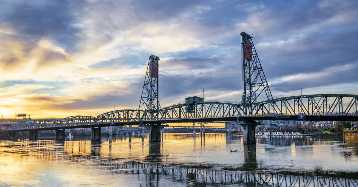 Can you sightsee in Portland, Oregon without a car? - Truss bridge over river under sundown sky Can you sightsee in Portland, Oregon without a car? - Truss bridge over river under sundown sky