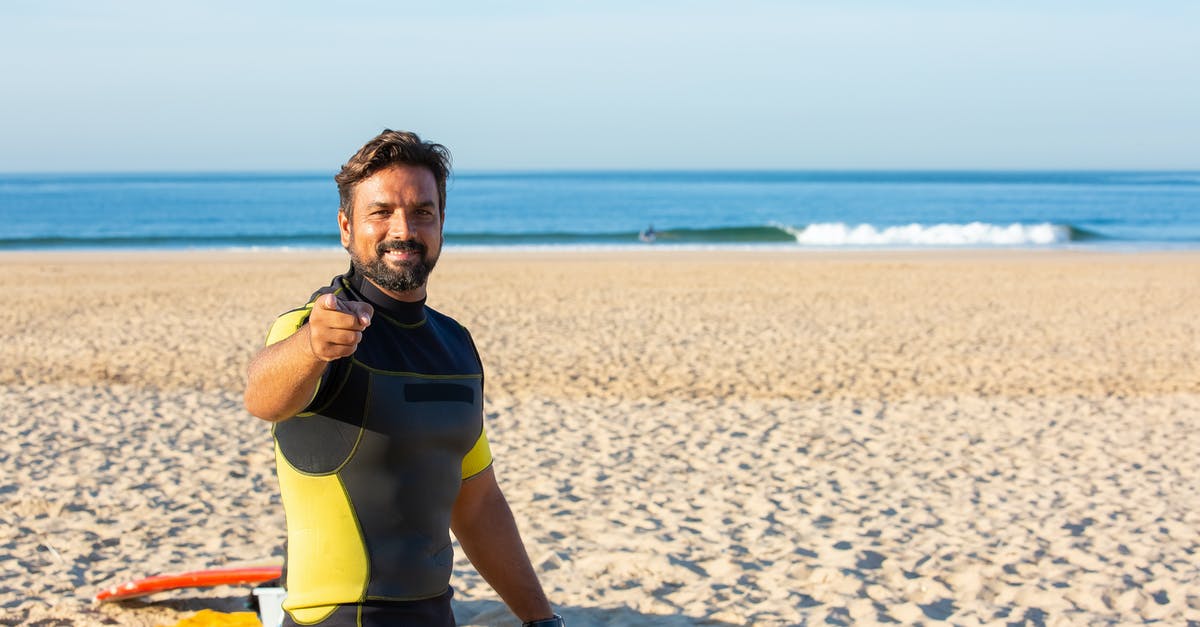 Can you transfer Qantas Frequent Flyer Points to other (non-family) members? - Happy male in diving suit looking and pointing at camera while standing on beach in bright sunny day Can you transfer Qantas Frequent Flyer Points to other (non-family) members? - Happy male in diving suit looking and pointing at camera while standing on beach in bright sunny day