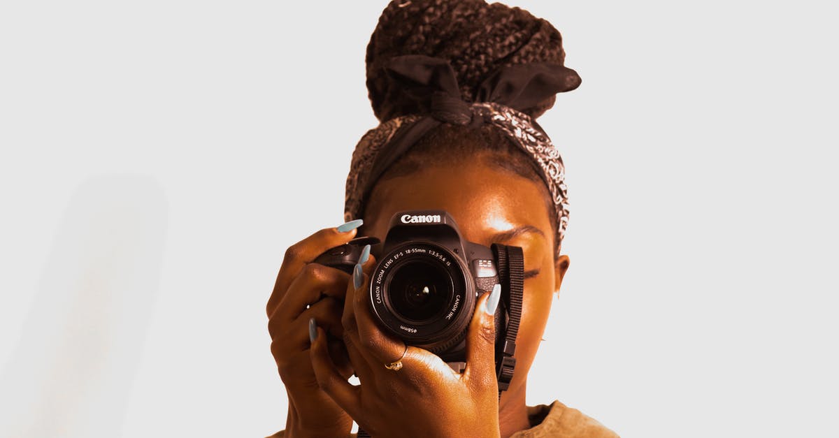Can you use a camera during take off and landing? - Woman Using Canon Dslr Camera
