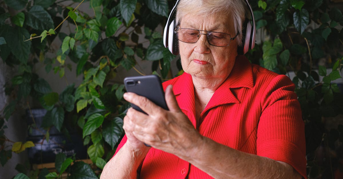 Can you use Canadian tablet-only SIM cards in a phone to make calls and receive text messages? - Elderly woman in headphones using smartphone near green leaves Can you use Canadian tablet-only SIM cards in a phone to make calls and receive text messages? - Elderly woman in headphones using smartphone near green leaves