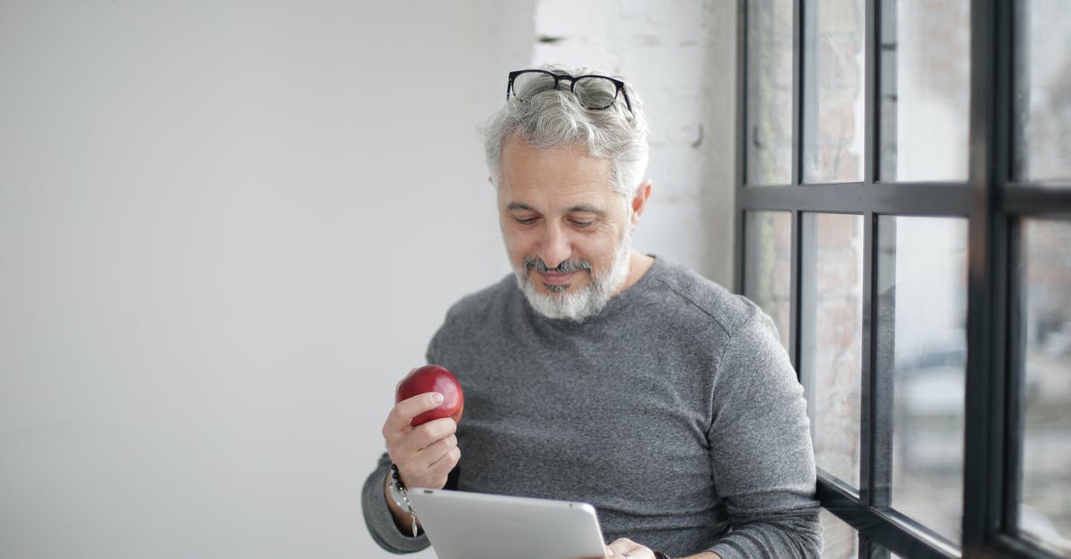 Can you work remote in Italy for a UK based company with just a tourist visa? - Middle aged bearded man in casual wear with eyeglasses on head watching video on tablet while having break with apple near window Can you work remote in Italy for a UK based company with just a tourist visa? - Middle aged bearded man in casual wear with eyeglasses on head watching video on tablet while having break with apple near window