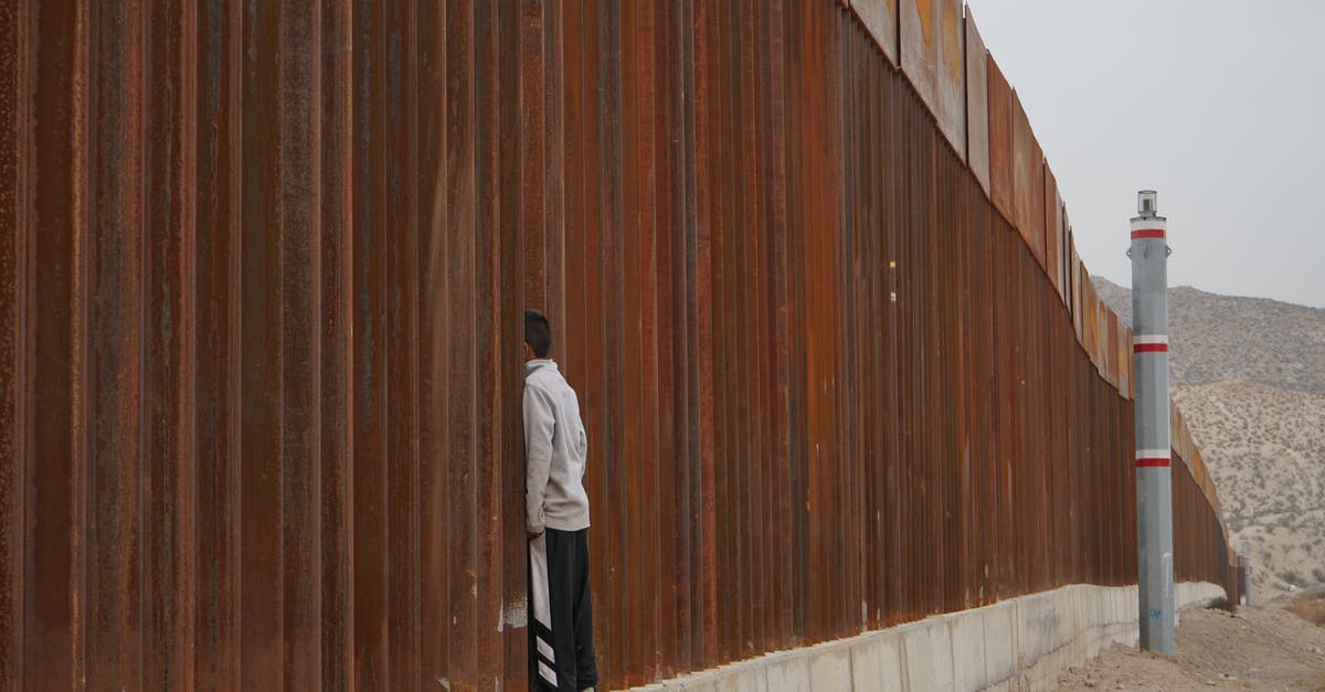 Canada's Automatic Border Clearance for visiting citizens - Man Standing on Fence Canada's Automatic Border Clearance for visiting citizens - Man Standing on Fence
