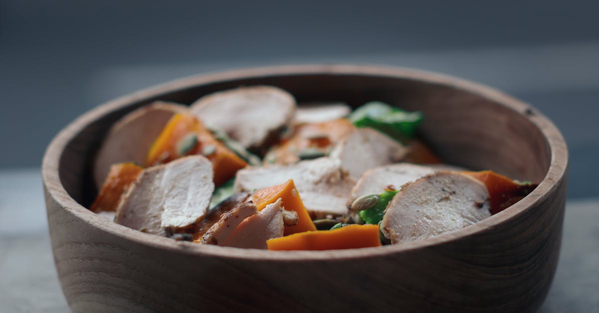Canada - cooked chicken from abroad for personal consumption - From above of appetizing salad with thin chicken slices and vegetables in wooden bowl on table Canada - cooked chicken from abroad for personal consumption - From above of appetizing salad with thin chicken slices and vegetables in wooden bowl on table