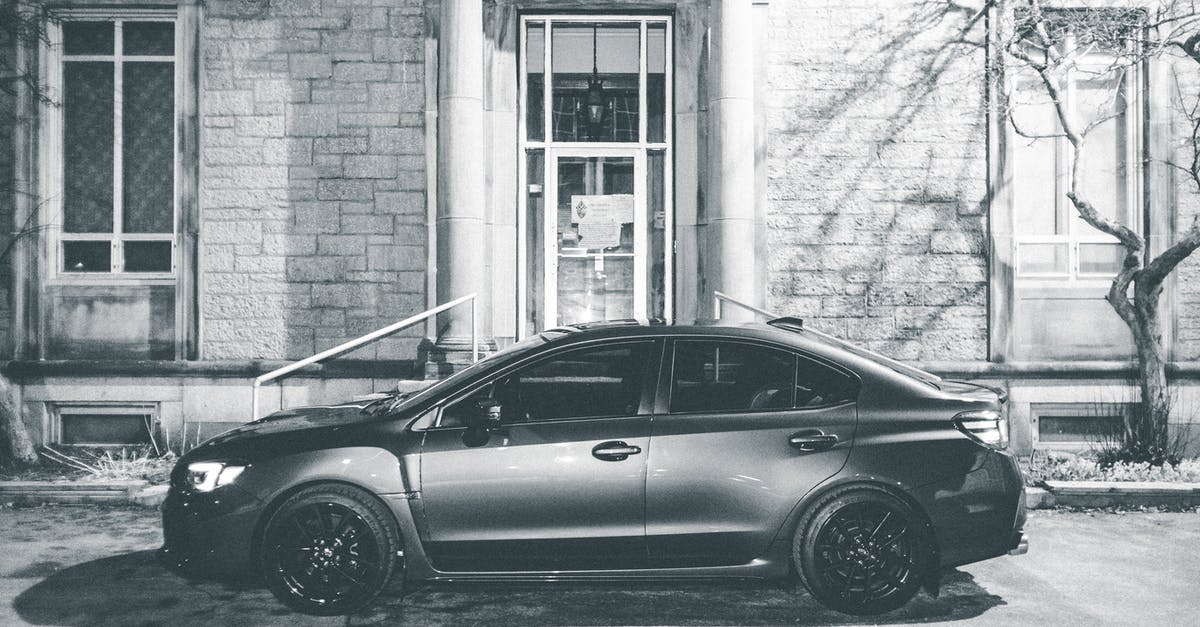 Canada: Entry by vehicle - Car parked near building in city Canada: Entry by vehicle - Car parked near building in city