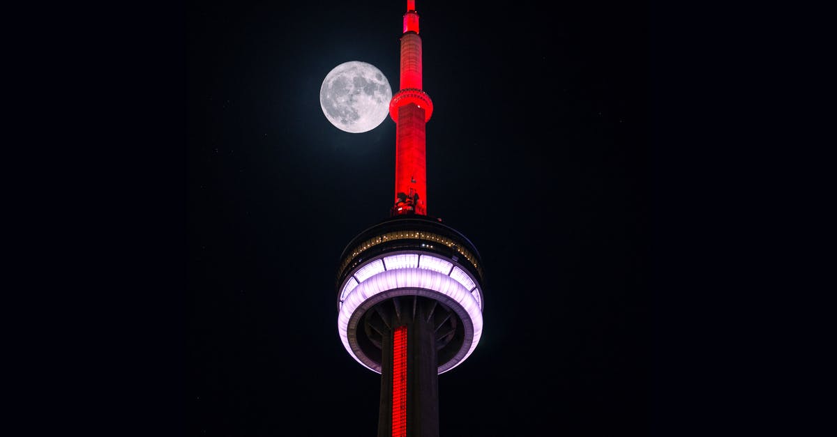 Canada Low Cost Airline - Low-angle Photography of Red and White Tower Canada Low Cost Airline - Low-angle Photography of Red and White Tower