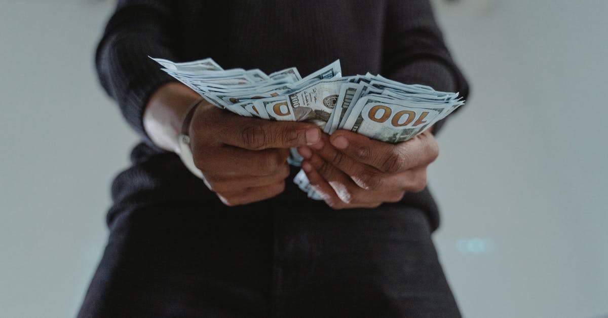 Canada visit visa for 15 days how much bank balance required [closed] - Close-Up Photo of a Person's Hands Holding Dollar Bank Notes