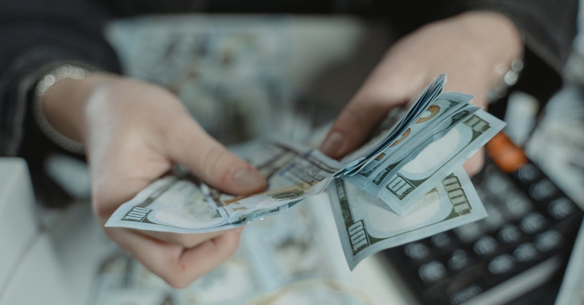 Canada visit visa for 15 days how much bank balance required [closed] - Close-Up Photo of a Person Counting Bank Notes