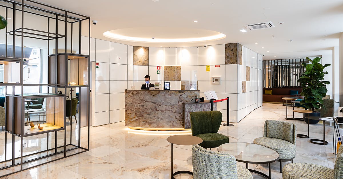 Canadian Expedia refund possibility for missed hotel - A Man in Black Suit Standing on Reception Area Canadian Expedia refund possibility for missed hotel - A Man in Black Suit Standing on Reception Area