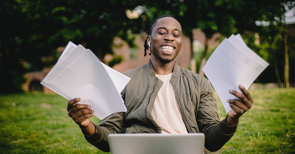 Cancelling Schengen Student Visa Application - Student with documents and laptop happy about getting into university Cancelling Schengen Student Visa Application - Student with documents and laptop happy about getting into university