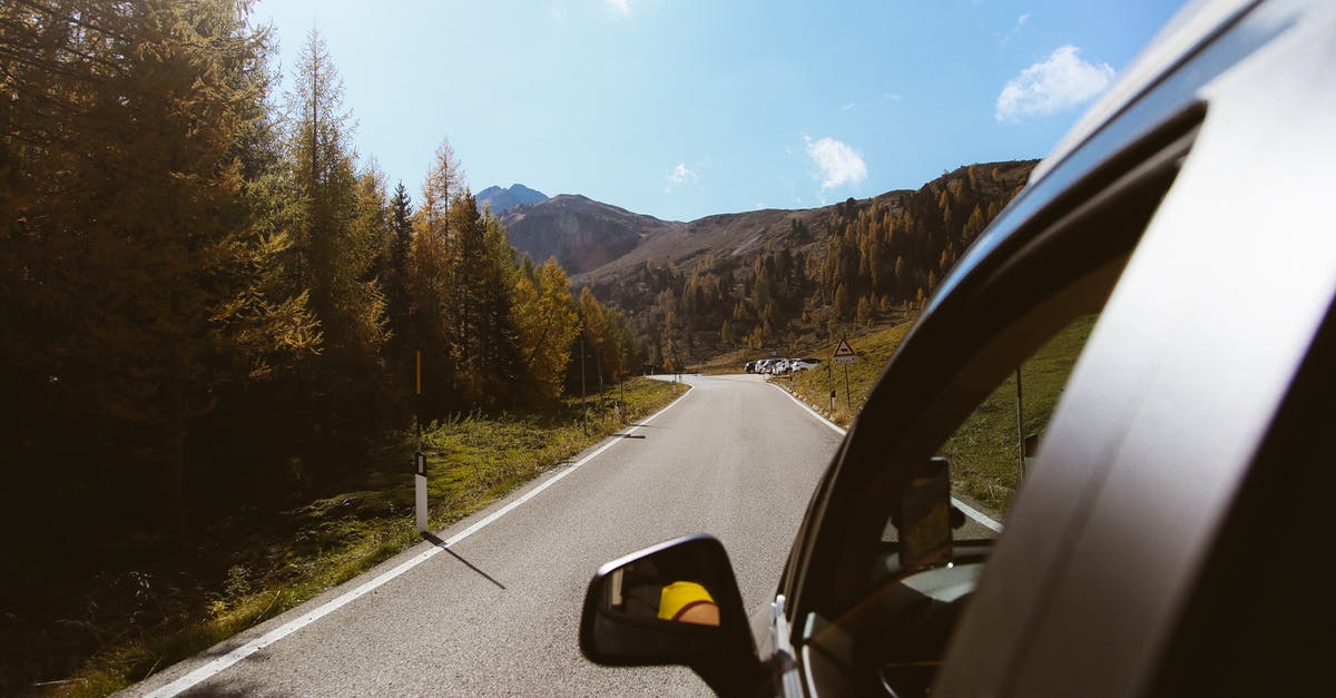 Car hire for driving from Bulgaria to Italy - A Car on the Road Between Trees Car hire for driving from Bulgaria to Italy - A Car on the Road Between Trees