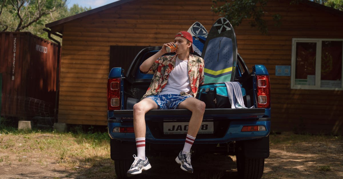 Car pick-up points in Rome - Teeanage Boy Sitting on Car Trunk and Drinking Mirinda Car pick-up points in Rome - Teeanage Boy Sitting on Car Trunk and Drinking Mirinda