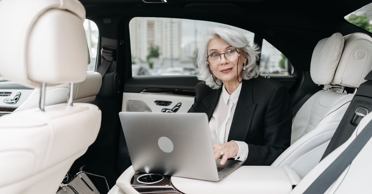 Car rental at 20 years old in UK - Woman in Black Suit Sitting on Car Seat Car rental at 20 years old in UK - Woman in Black Suit Sitting on Car Seat