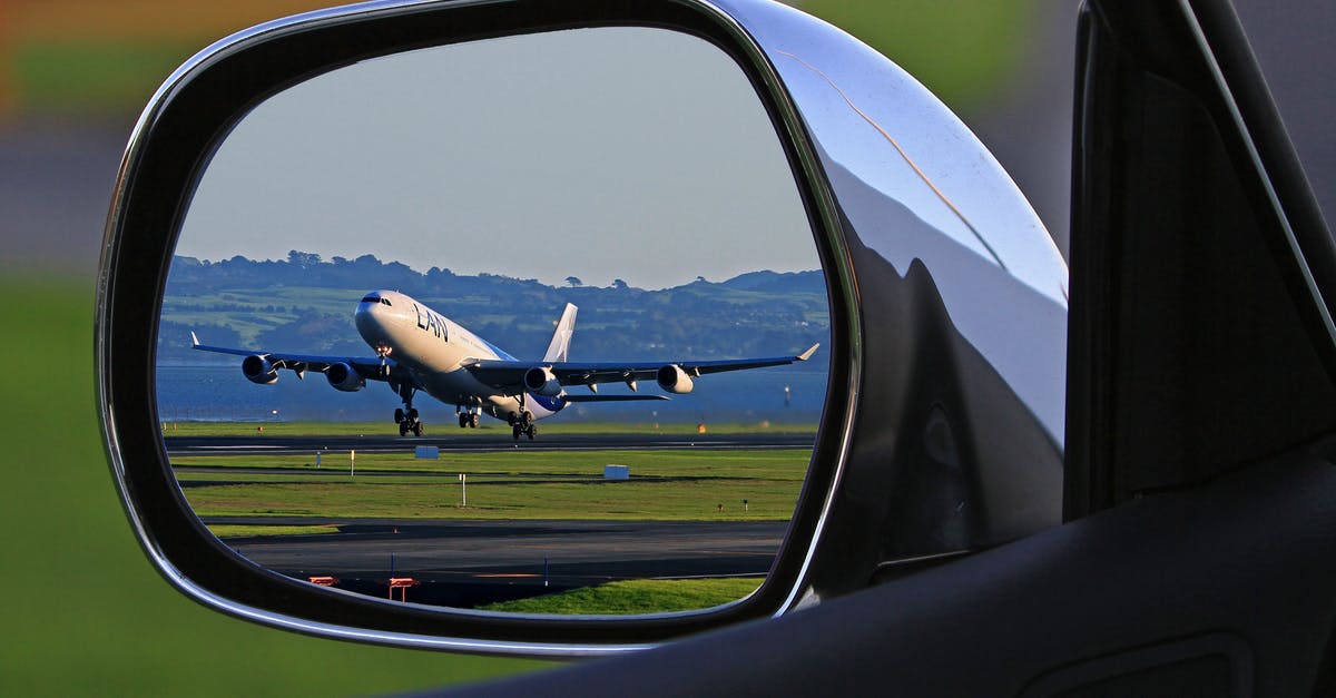 Car Rental at Milan Airport - White Airplane Reflection on Car Side Mirror Car Rental at Milan Airport - White Airplane Reflection on Car Side Mirror