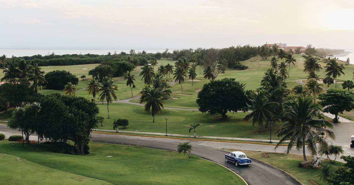 Car rental in Cuba - Vintage Car Passing Golf Course Car rental in Cuba - Vintage Car Passing Golf Course