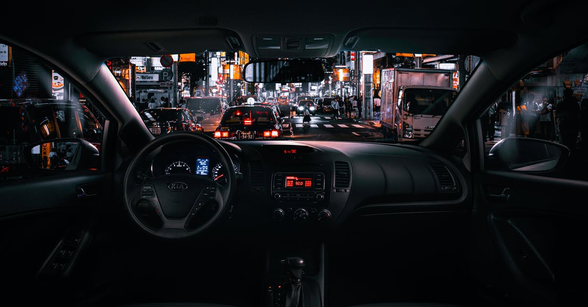 Car rental in Japan - Black Car Steering Wheel and Interior during Night Time Car rental in Japan - Black Car Steering Wheel and Interior during Night Time