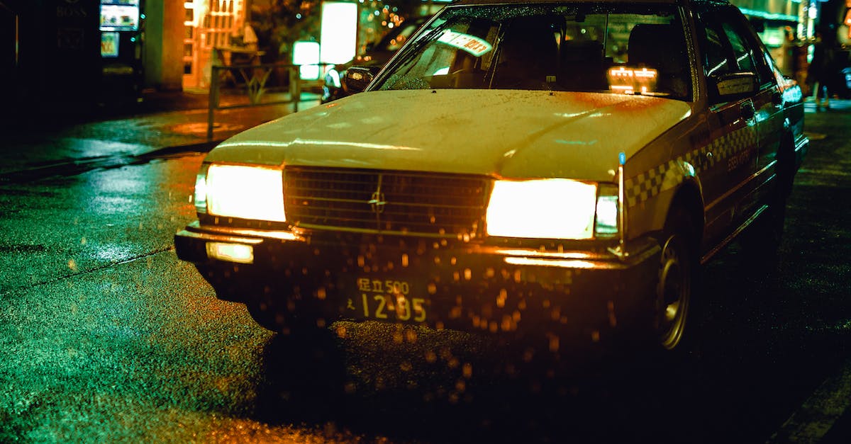 Car rental in Japan - White Sedan during Nighttime Car rental in Japan - White Sedan during Nighttime