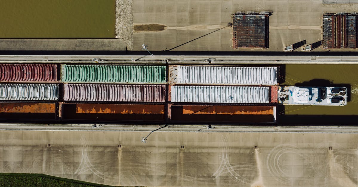 Carry a drone during a Dubai/Seychelles trip - Barge traffic with containers on water channel Carry a drone during a Dubai/Seychelles trip - Barge traffic with containers on water channel
