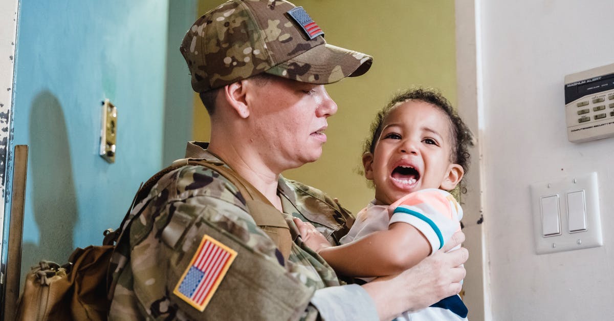 Carrying US Kevlar ACH out of the US - Person Carrying a Crying Little Boy Carrying US Kevlar ACH out of the US - Person Carrying a Crying Little Boy