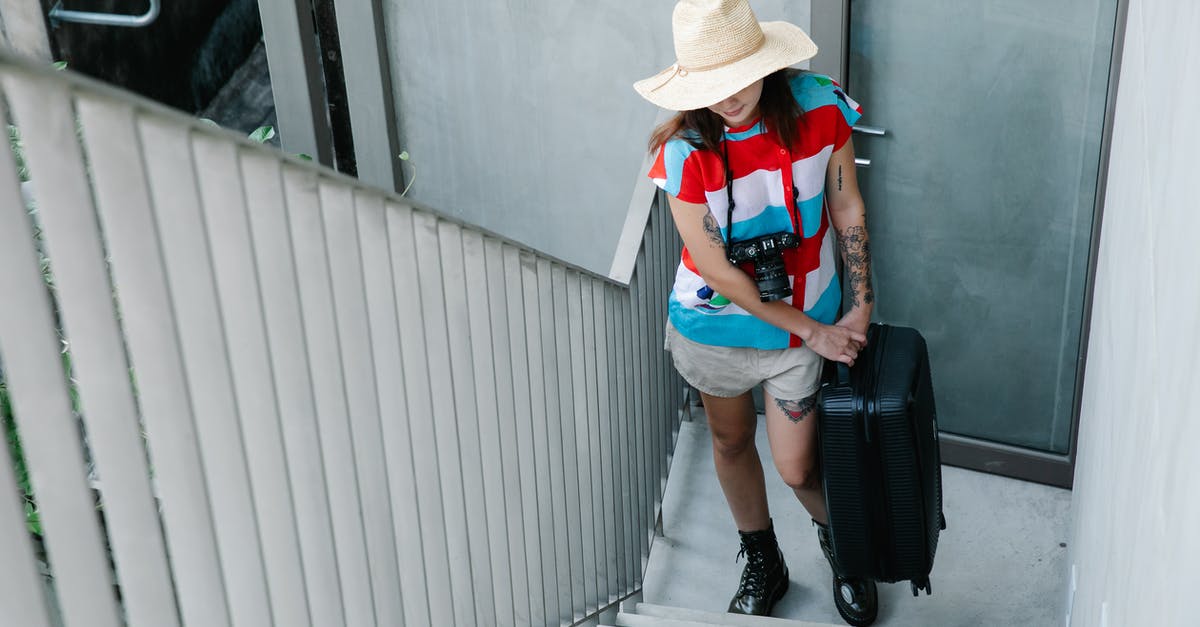 Carry-on baggage restrictions for United Airlines? - A Woman Wearing Hat Carrying a Baggage Carry-on baggage restrictions for United Airlines? - A Woman Wearing Hat Carrying a Baggage