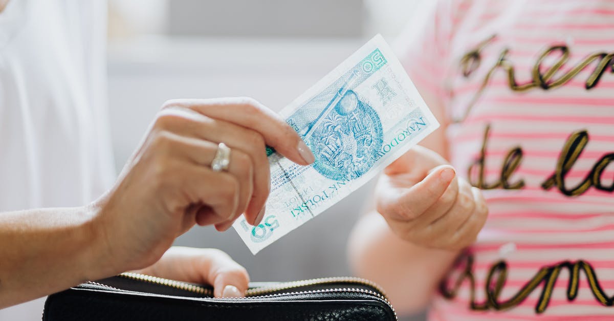Cash allowance while transiting through Zurich - Person Holding a 50 Polish Zloty Bill Cash allowance while transiting through Zurich - Person Holding a 50 Polish Zloty Bill