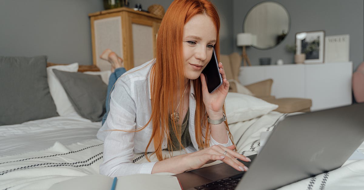Cellphone carriers in Europe - Woman in White Blazer Using Silver Macbook Cellphone carriers in Europe - Woman in White Blazer Using Silver Macbook