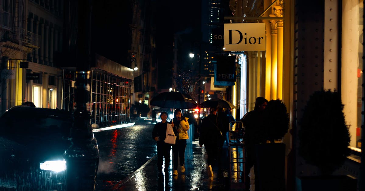 Central America, rain season and electronics - Contemporary urban city street with driving cars and walking pedestrians on rainy autumn evening Central America, rain season and electronics - Contemporary urban city street with driving cars and walking pedestrians on rainy autumn evening