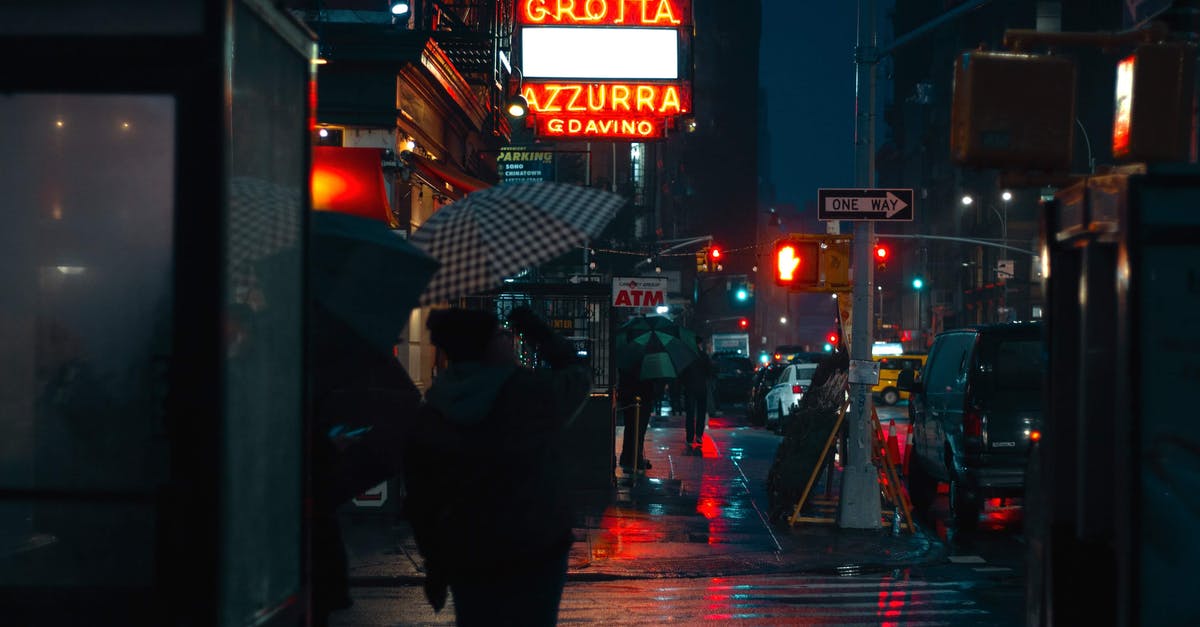 Central America, rain season and electronics - Busy urban city street crowded with pedestrians and illuminated by electric lights in rainy autumn evening Central America, rain season and electronics - Busy urban city street crowded with pedestrians and illuminated by electric lights in rainy autumn evening