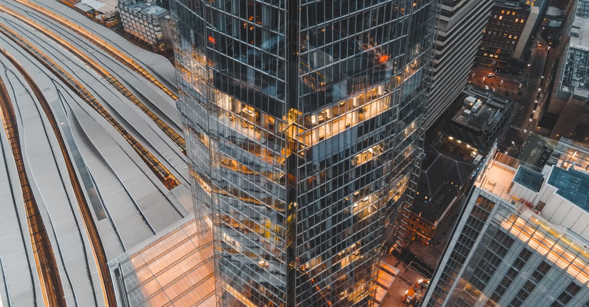 Central districts in London? - Drone view of London city located in England with tall Shard skyscraper near buildings and railways in daytime Central districts in London? - Drone view of London city located in England with tall Shard skyscraper near buildings and railways in daytime