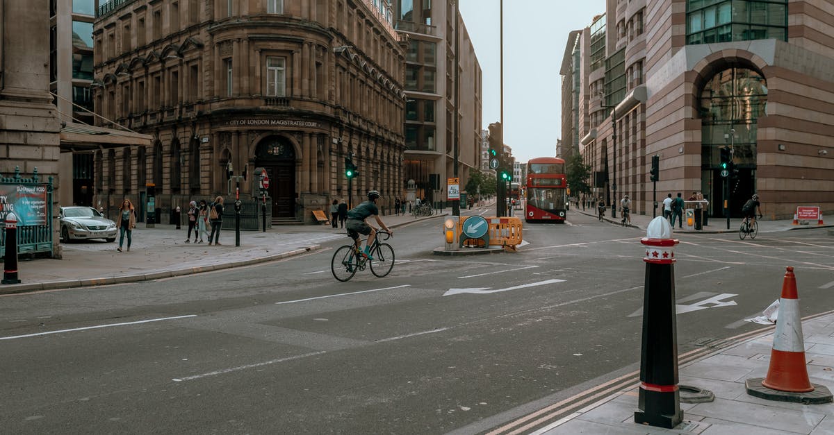 Chaining bikes in London - Man in Black Jacket Riding Bicycle on Road Chaining bikes in London - Man in Black Jacket Riding Bicycle on Road