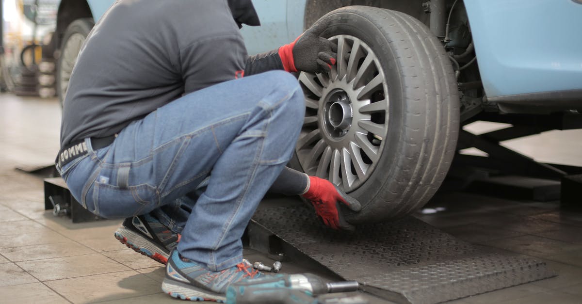 changing airlines in Houston - Man Changing a Car Tire changing airlines in Houston - Man Changing a Car Tire