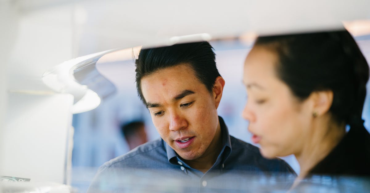 Changing business flight date [closed] - Closeup Photo of Man Standing Beside Woman Wearing Black Shirt