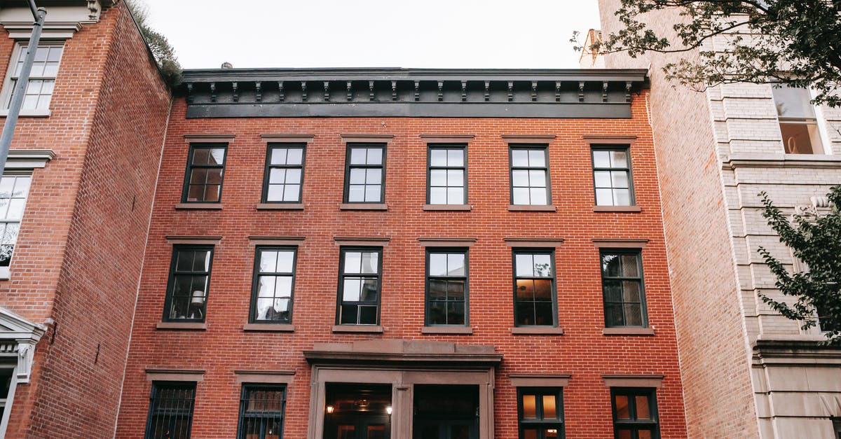 Changing from single entry to multiple entry visa - Facade of brick house with black window frames Changing from single entry to multiple entry visa - Facade of brick house with black window frames